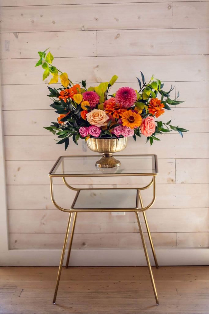 Colorful Summer wedding centerpiece on modern gold table at The Ruby Street