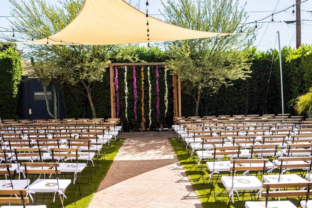 Colorful hanging garland arch ceremony at The Ruby Street Los Angeles