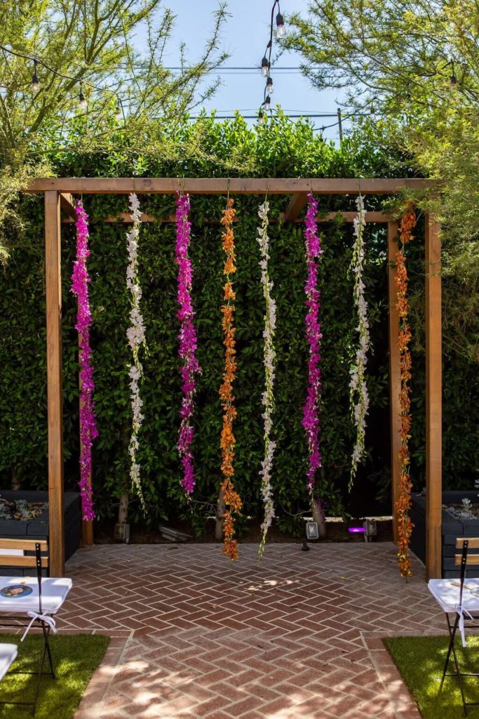 Colorful hanging garland arch ceremony at The Ruby Street