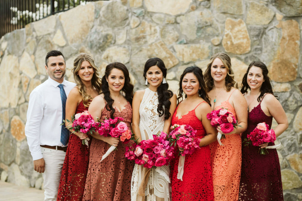 Fiesta inspired outdoor wedding bridal party with colorful dresses pink bouquets