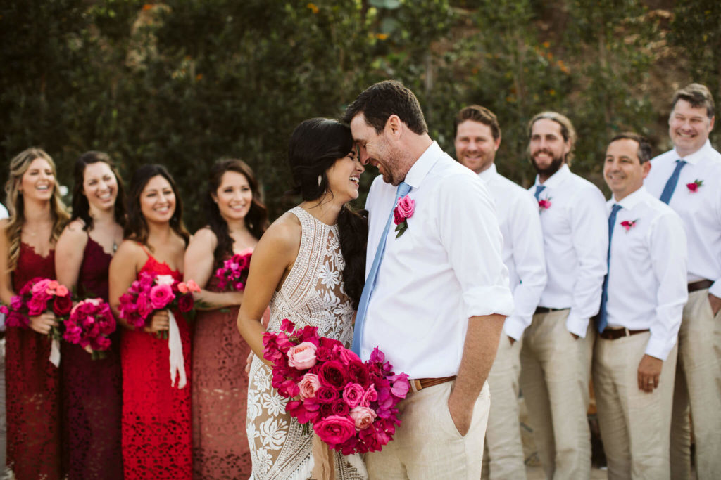 Fiesta inspired wedding with pink flowers and colorful bridesmaid dresses