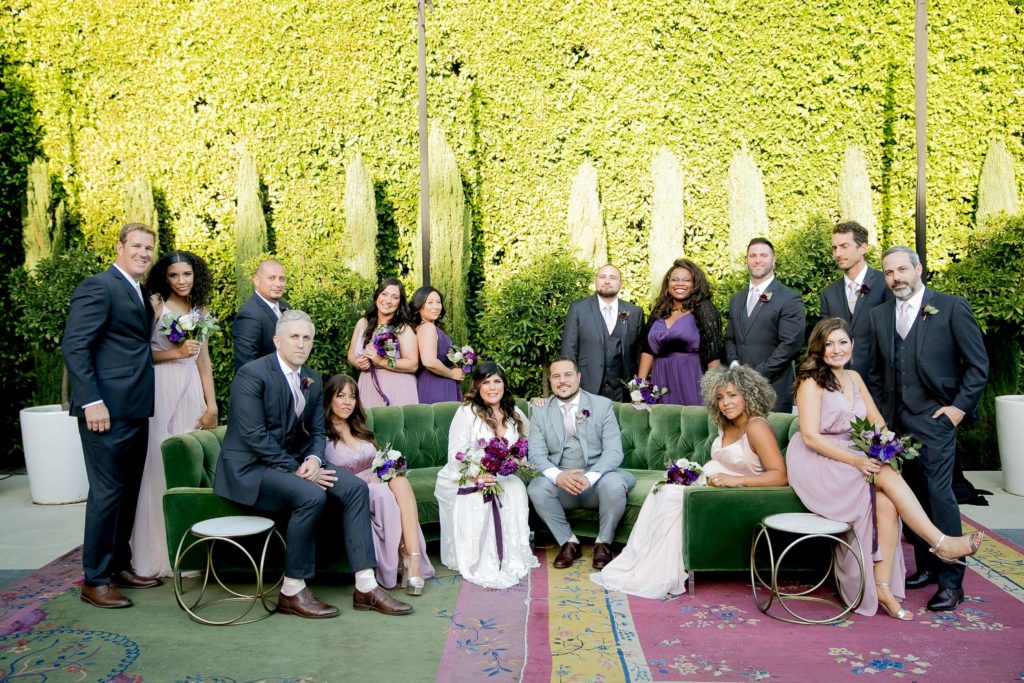 Wedding party group photo on green couch at The Fig House Los Angeles