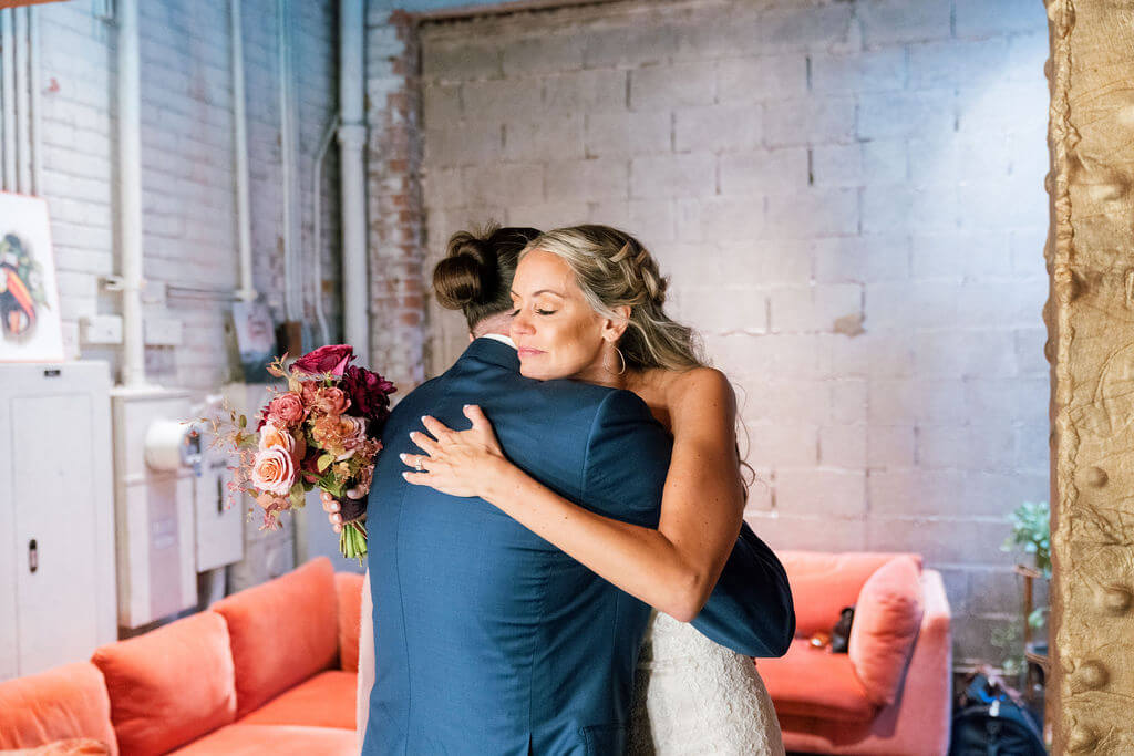 Bride and groom hugging at modern industrial LA wedding