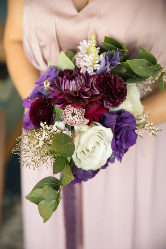Bridesmaid bouquet with purple flowers and greenery