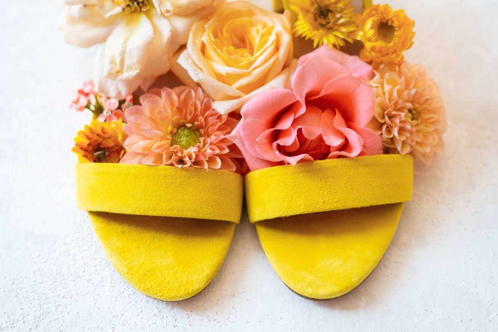 Bright yellow bridal shoes with pink, orange, and yellow florals