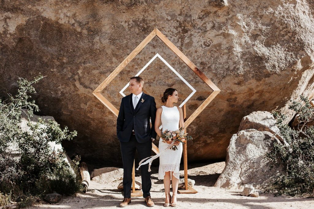 Bride and groom geometric arch wedding ceremony in Joshua Tree