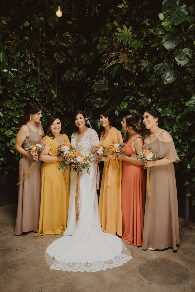Fall wedding bridal party with colorful bridesmaid dresses and bouquets at The Wood Shed California