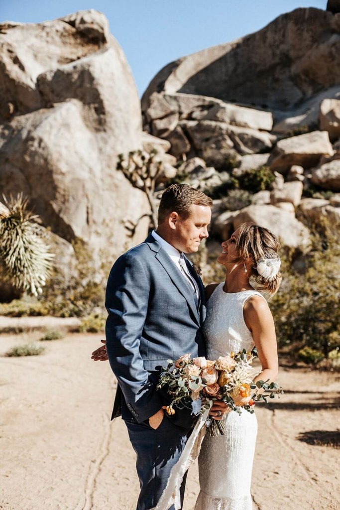 Groom and bride holding her bouquet in Joshua Tree wedding ceremony 
