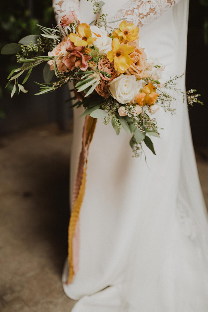 Modern Fall wedding bouquet with orange yellow toffee and peach flowers with eucalyptus