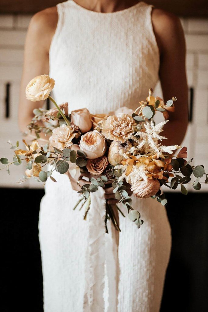 Bridal bouquet with yellow peach mauve and white flowers in Joshua Tree