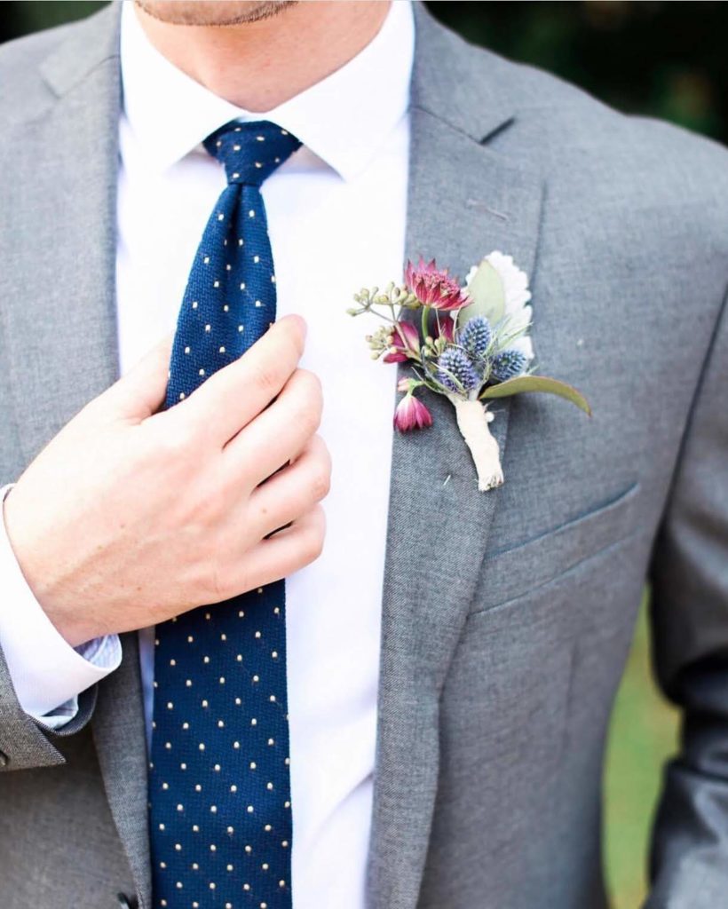 Organic blue and burgundy winter wedding gray suit with blue thistle boutonniere