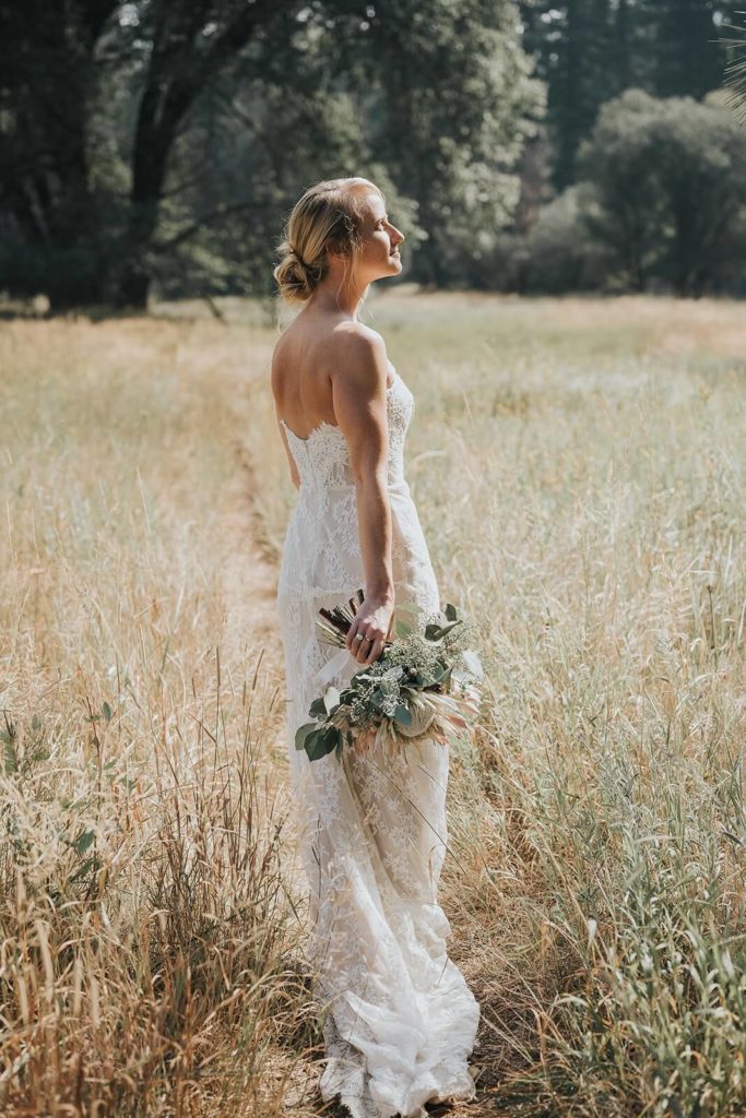 Bride in an open grassy field in Yosemite