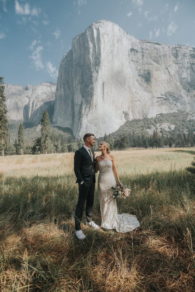 Yosemite elopement bride and groom in a grassy area in front of El Capitan