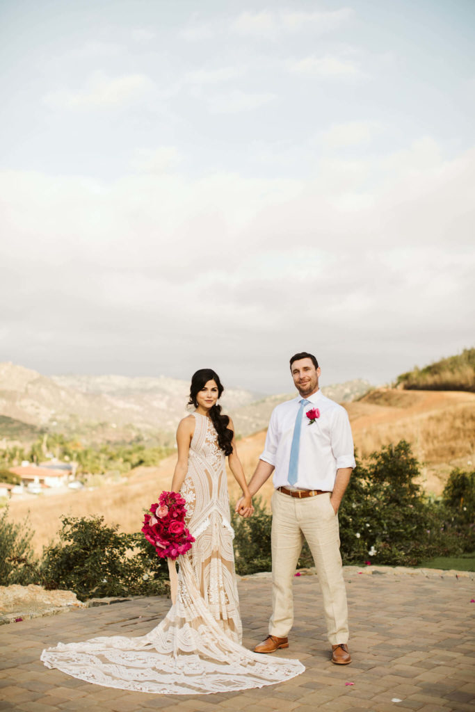Outdoor pink bougainvillea wedding bride and groom