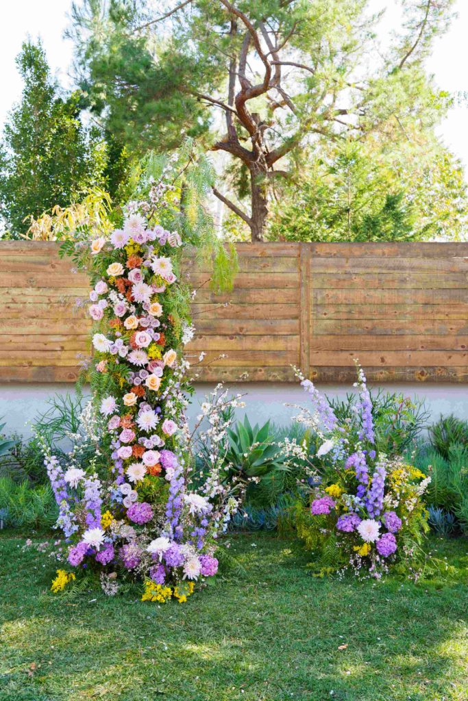 Colorful garden inspired wedding arch