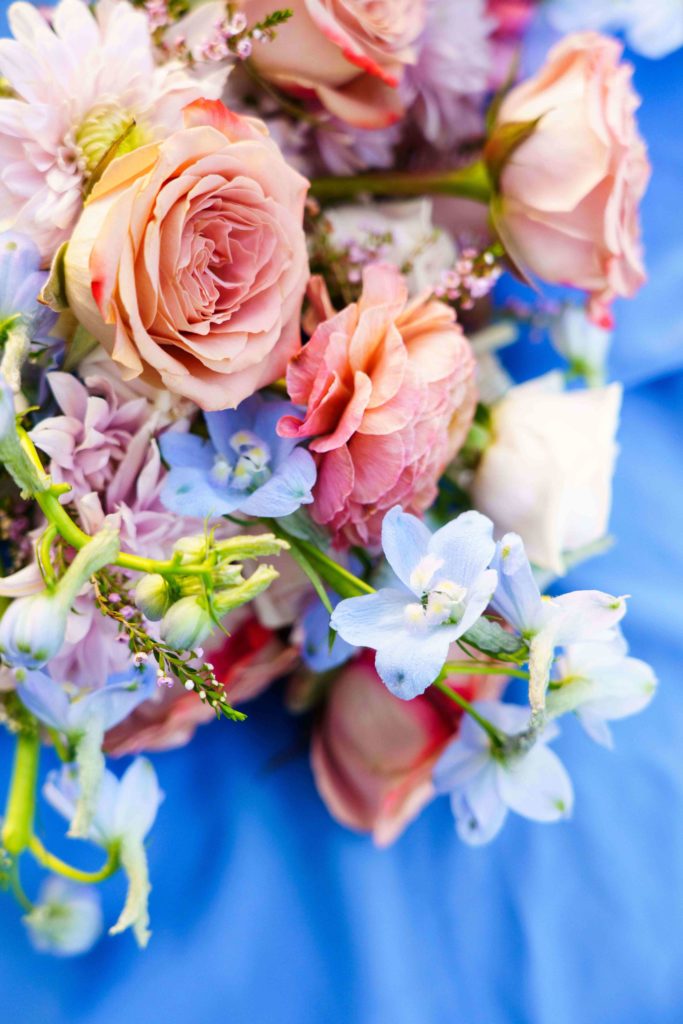 Colorful wedding bouquet with pink and light blue flowers