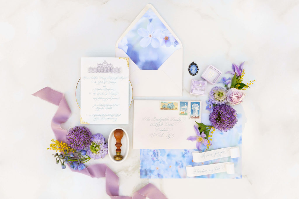 Bridgerton wedding inspired stationery suite with lavender and yellow florals and wedding rings