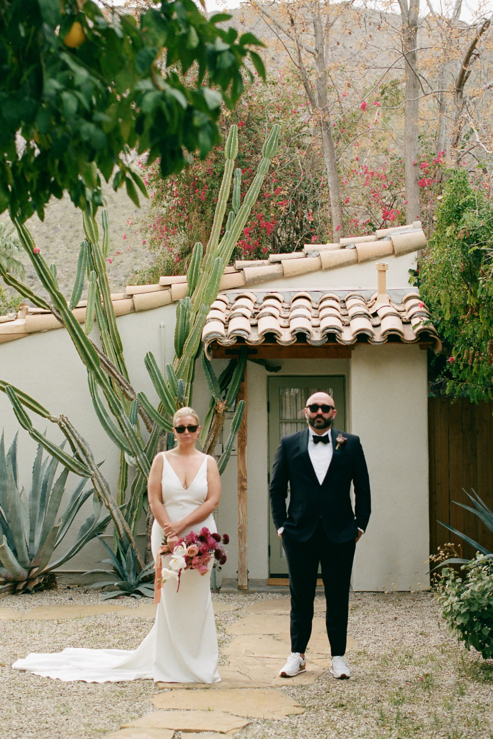 Bride and groom posing with sunglasses at Casa Cody venue for Palm Springs wedding