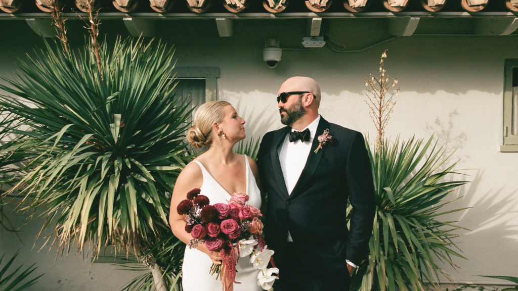 Modern couple with berry bouquet and sunglasses at Palm Springs wedding