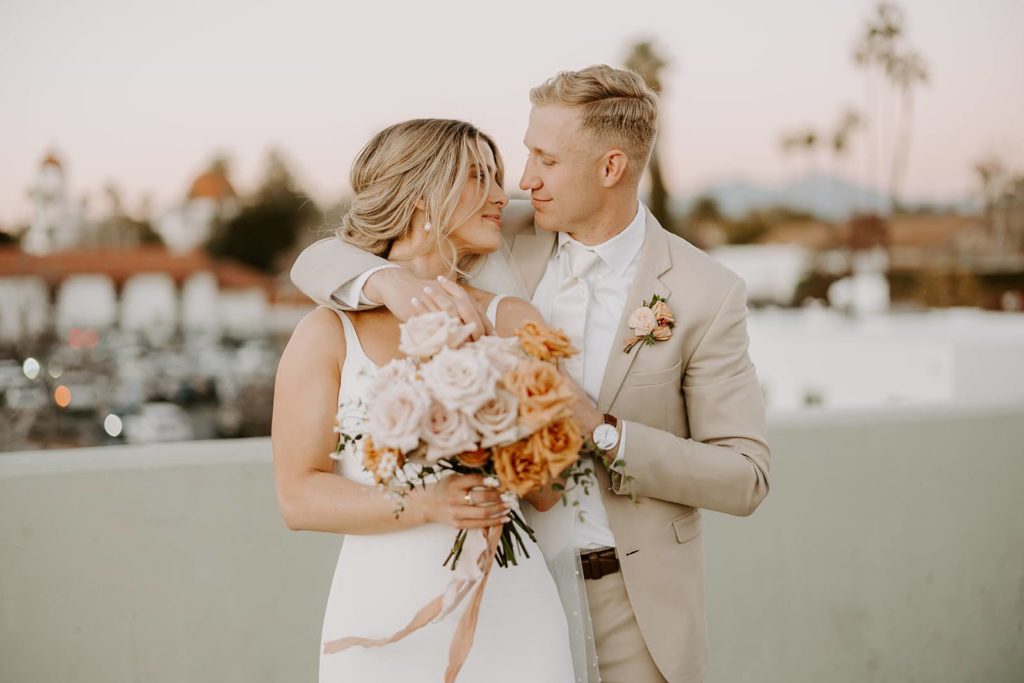Bride and groom photography with peach and neutral wedding bouquet