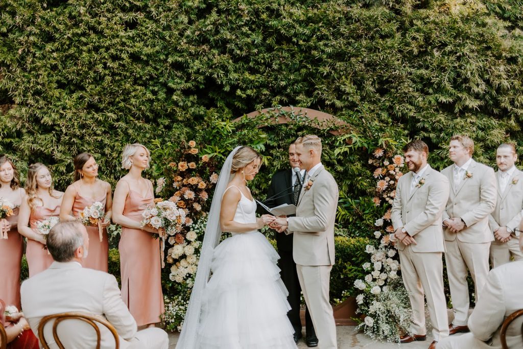 Bride and groom exchanging vows at outdoor ceremony in California