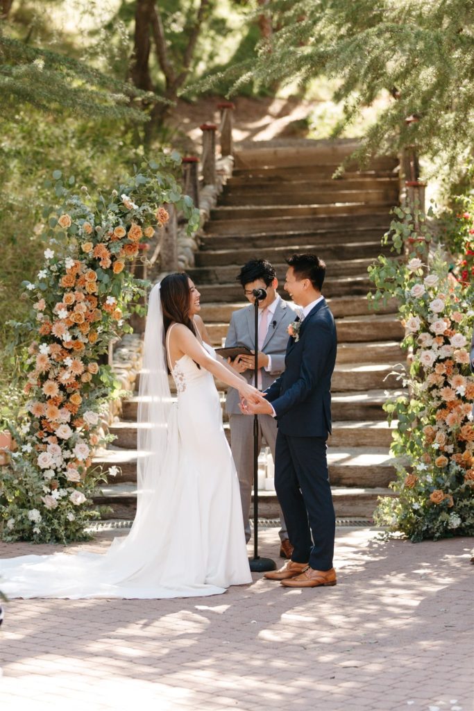 Bride and groom laughing at wedding ceremony at Rancho Las Lomas 