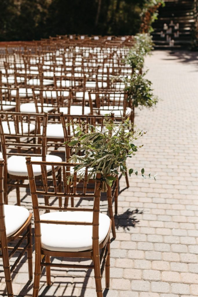 Greenery on wedding ceremony chairs at Rancho Las Lomas wedding