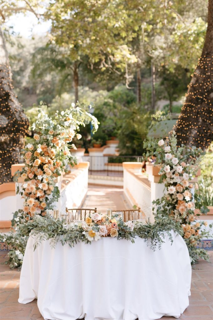 Peach and cream fresh floral arch for wedding reception