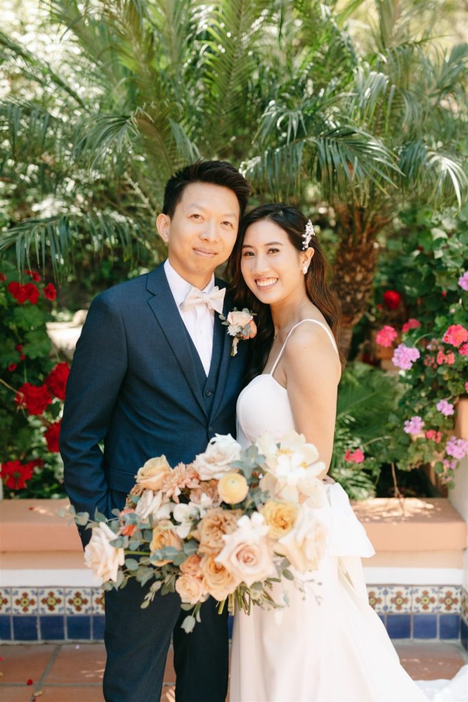 Bride and Groom smiling at Southern California wedding with bouquet