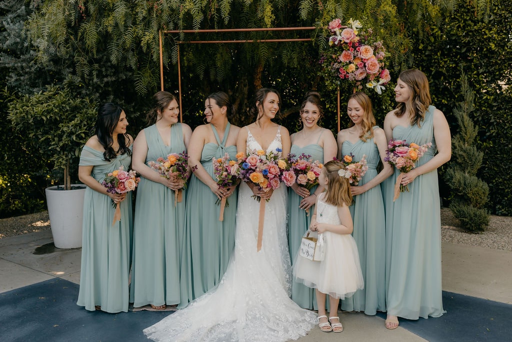 Bride and bridesmaids at outdoor ceremony space at The Fig House wedding venue
