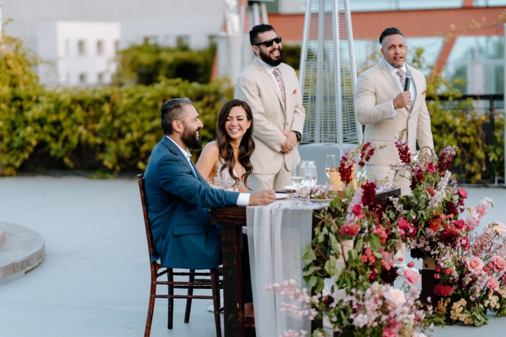 Bride and groom at outdoor sweatheart table at Malibu wedding