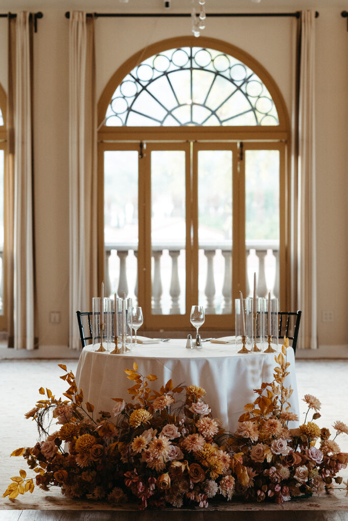 Fall Sweetheart table florals and taper candles in Sandstone