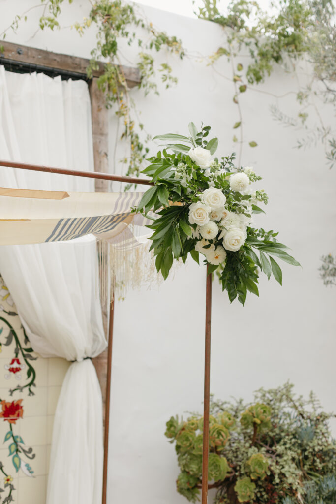 Copper Chuppah floral accent with white flowers and greenery