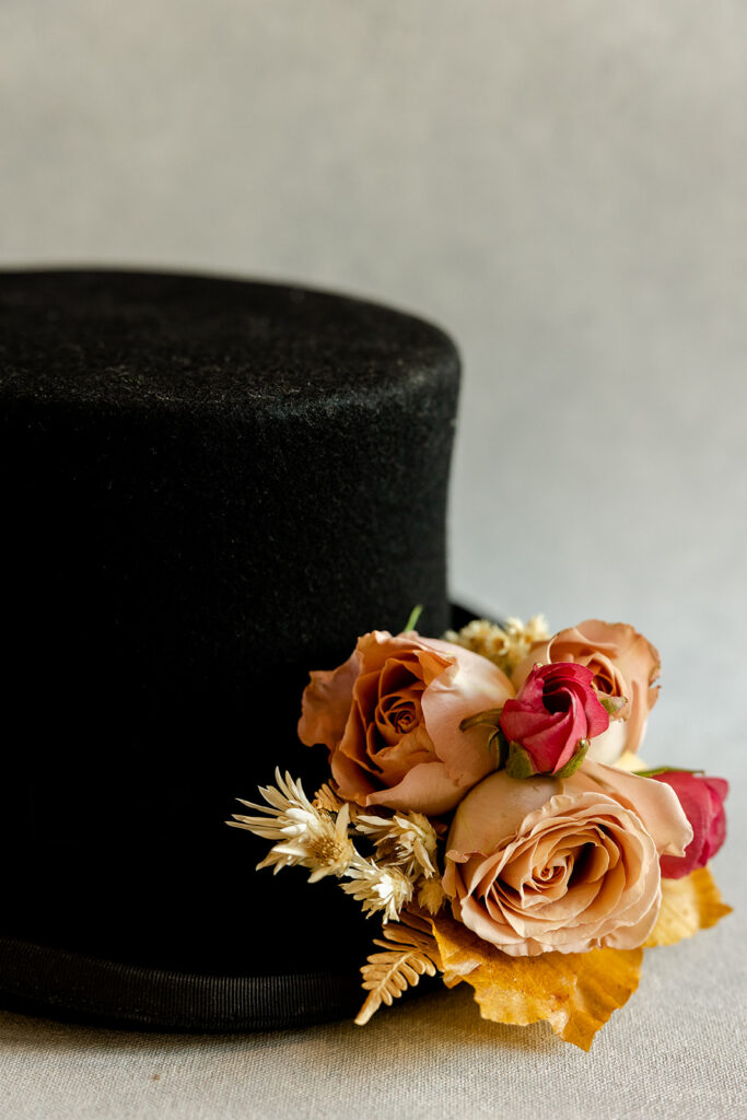 Black top hat with bouttonniere