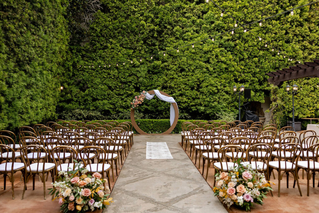 Franciscan Gardens wedding ceremony with circle arch florals and aisle florals