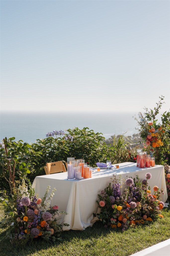 sweetheart table with flower installation for an outdoor malibu wedding