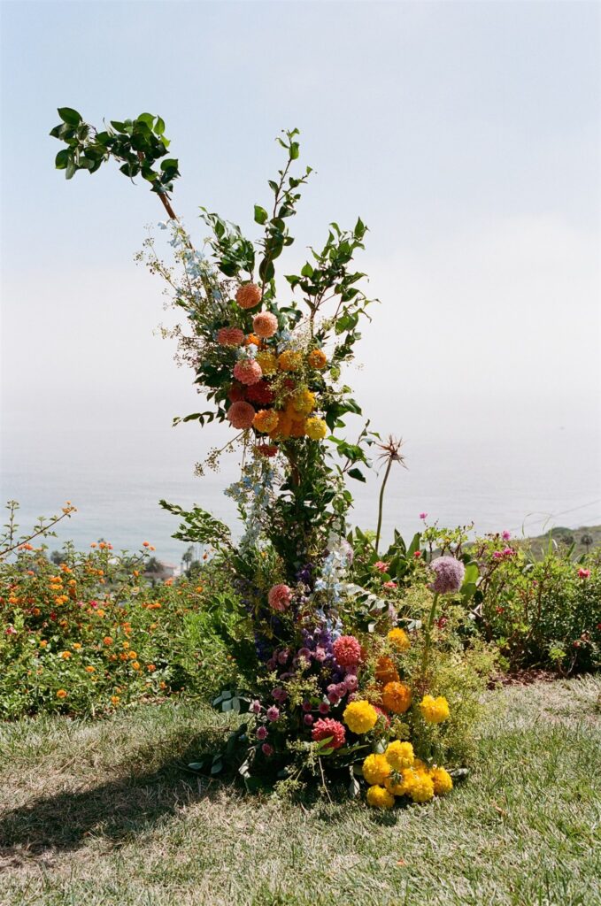 wedding ceremony flower installation with dahlias and marigolds