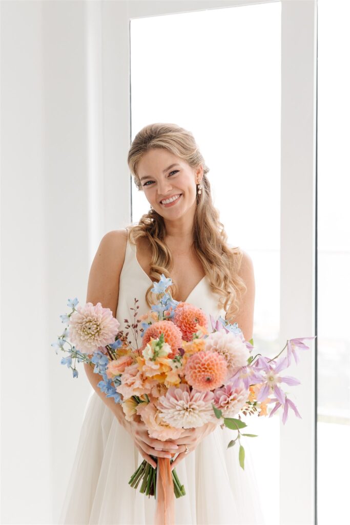 bride holding summer flower bridal bouquet designed by urban marigold