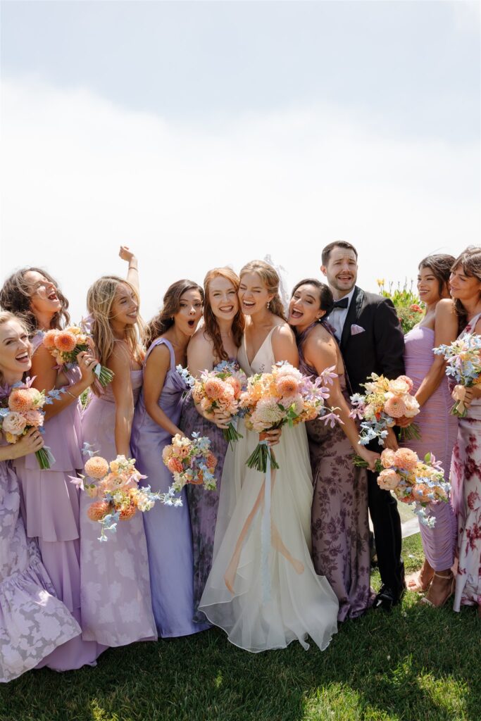 bridal party colorful dresses and bouquets for a vibrant summer wedding